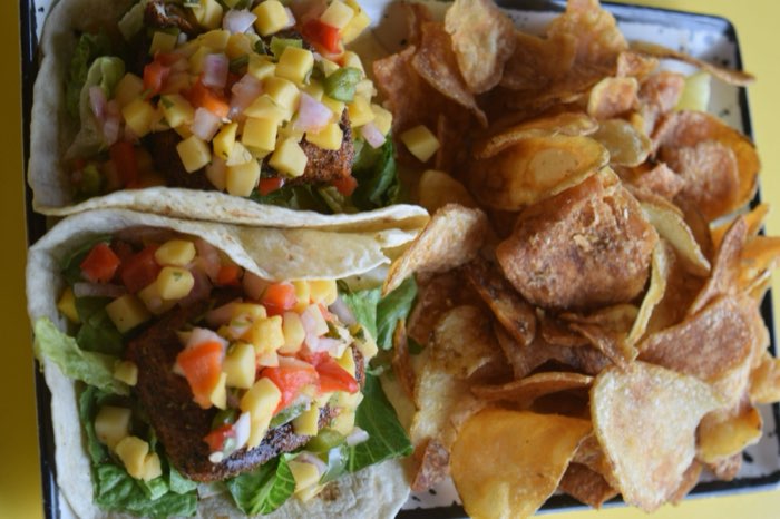 Sandwich and chips on a red table